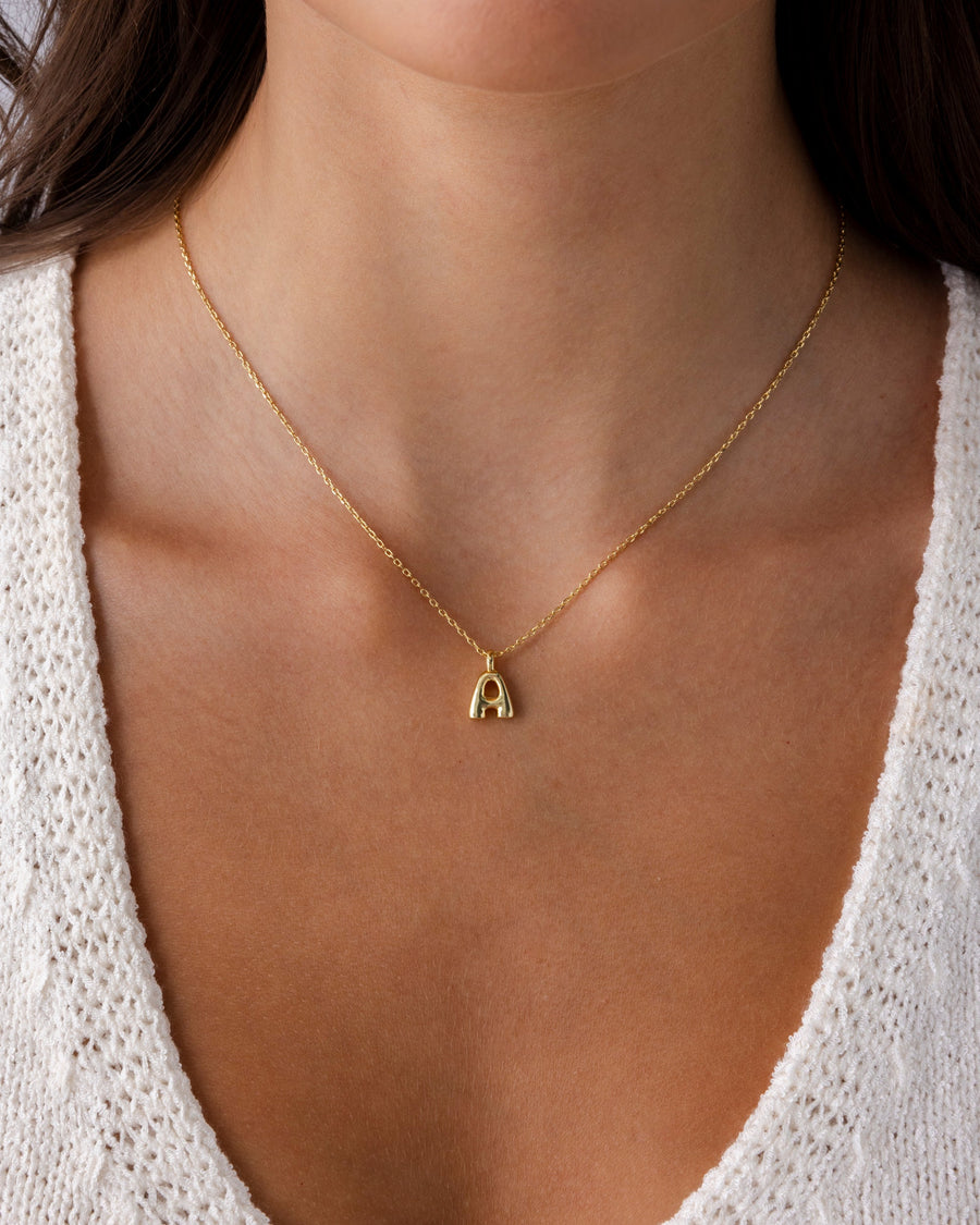 Yellow Gold Fenna Initial Bubble Pendant — worn on the collarbone