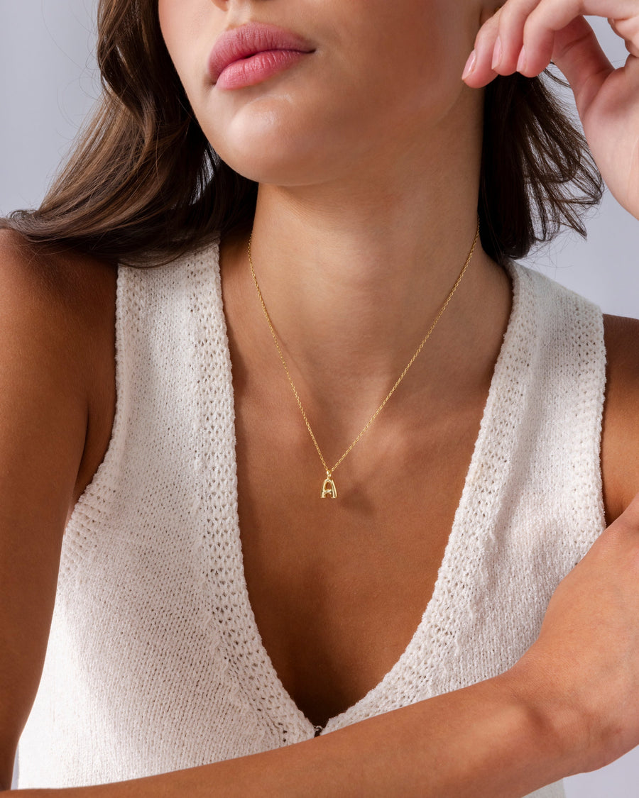 Yellow Gold Fenna Initial Bubble Pendant — worn close up