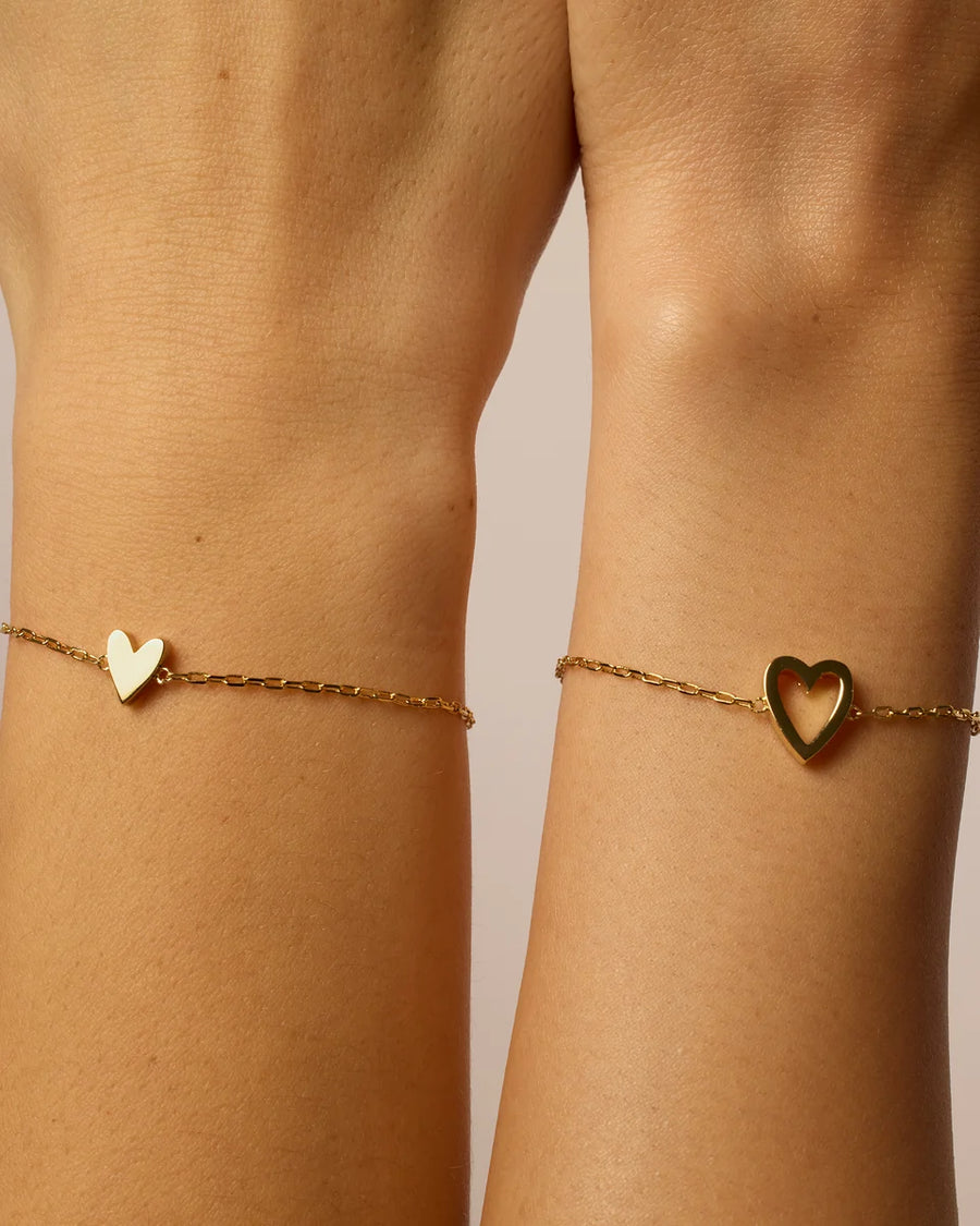 Yellow Gold Nova Heart Bolo Bracelet — both charm styles worn